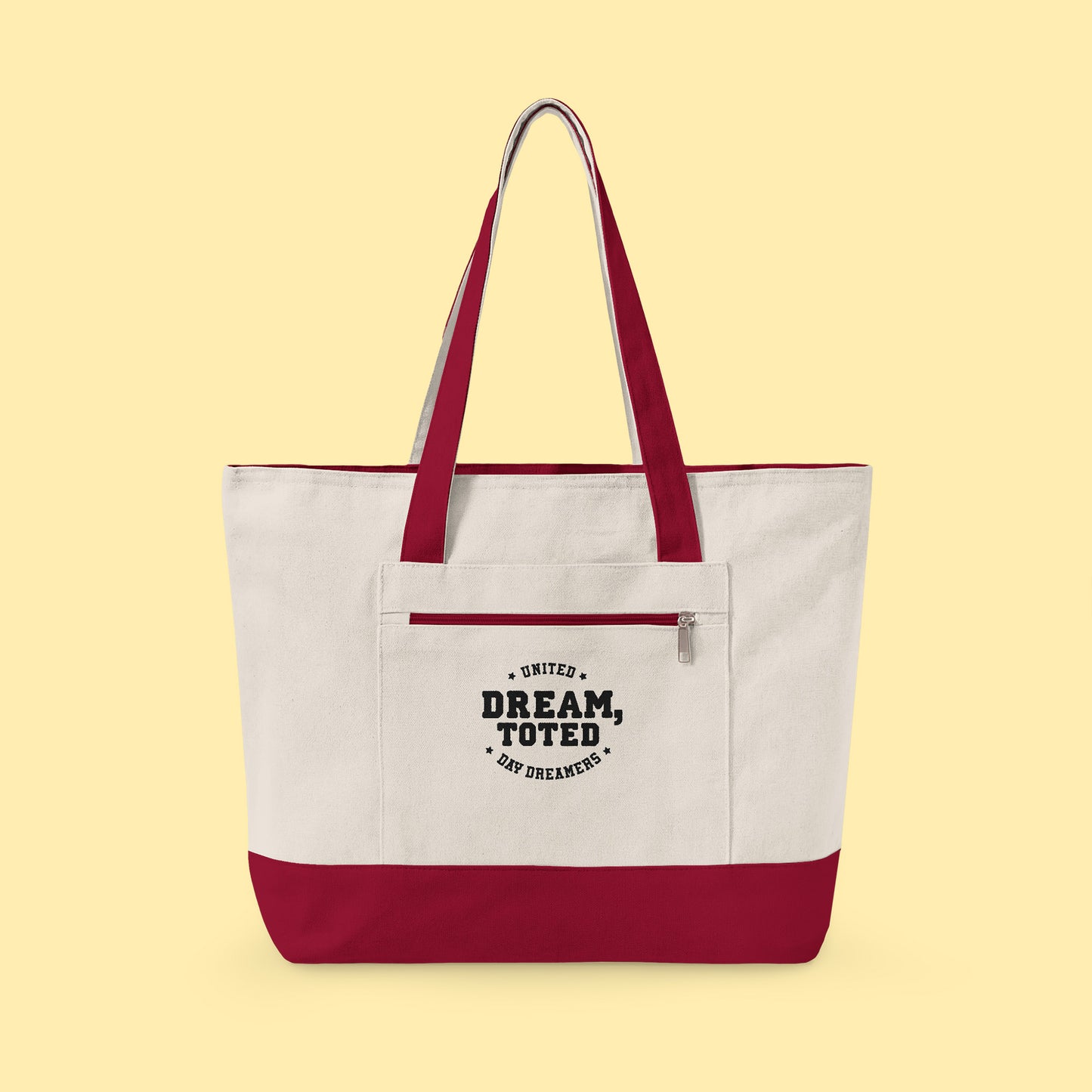 Tote with red accents and text that reads, Dream, Toted. United Day Dreamers on a light yellow background