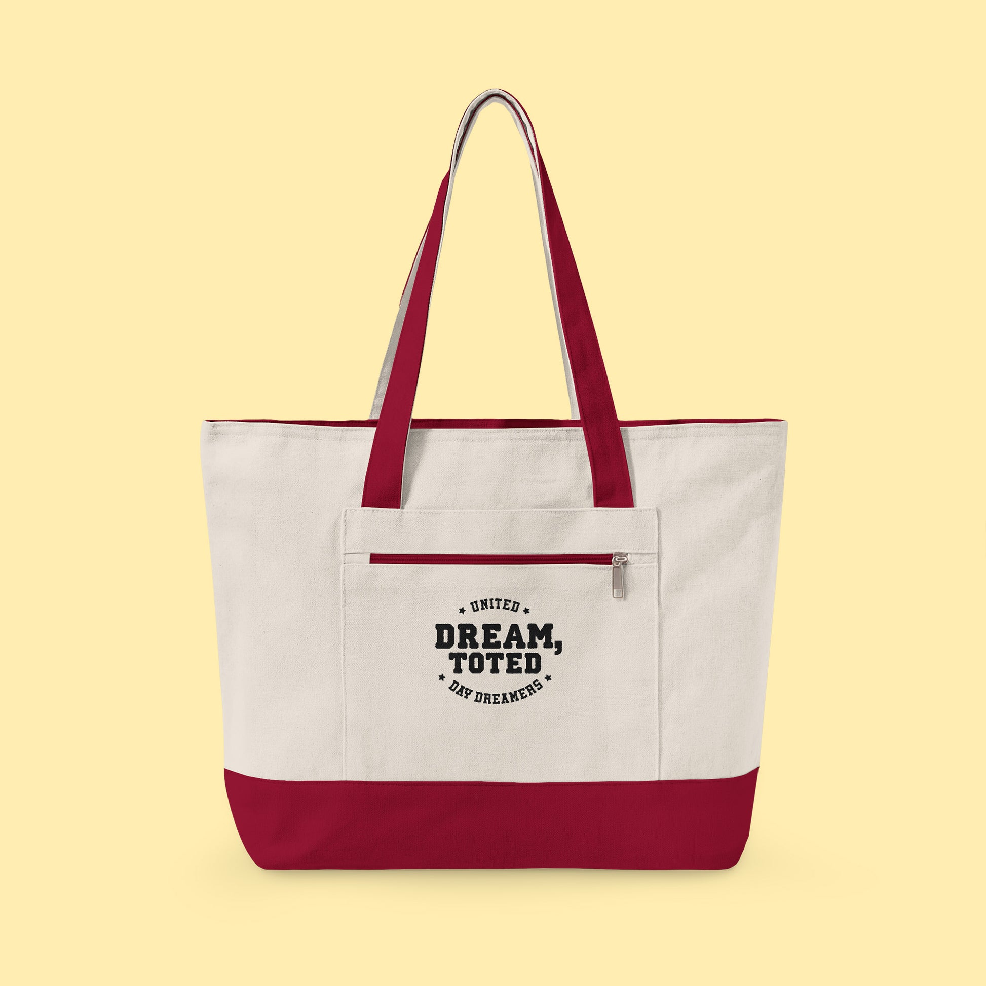 Tote with red accents and text that reads, Dream, Toted. United Day Dreamers on a light yellow background