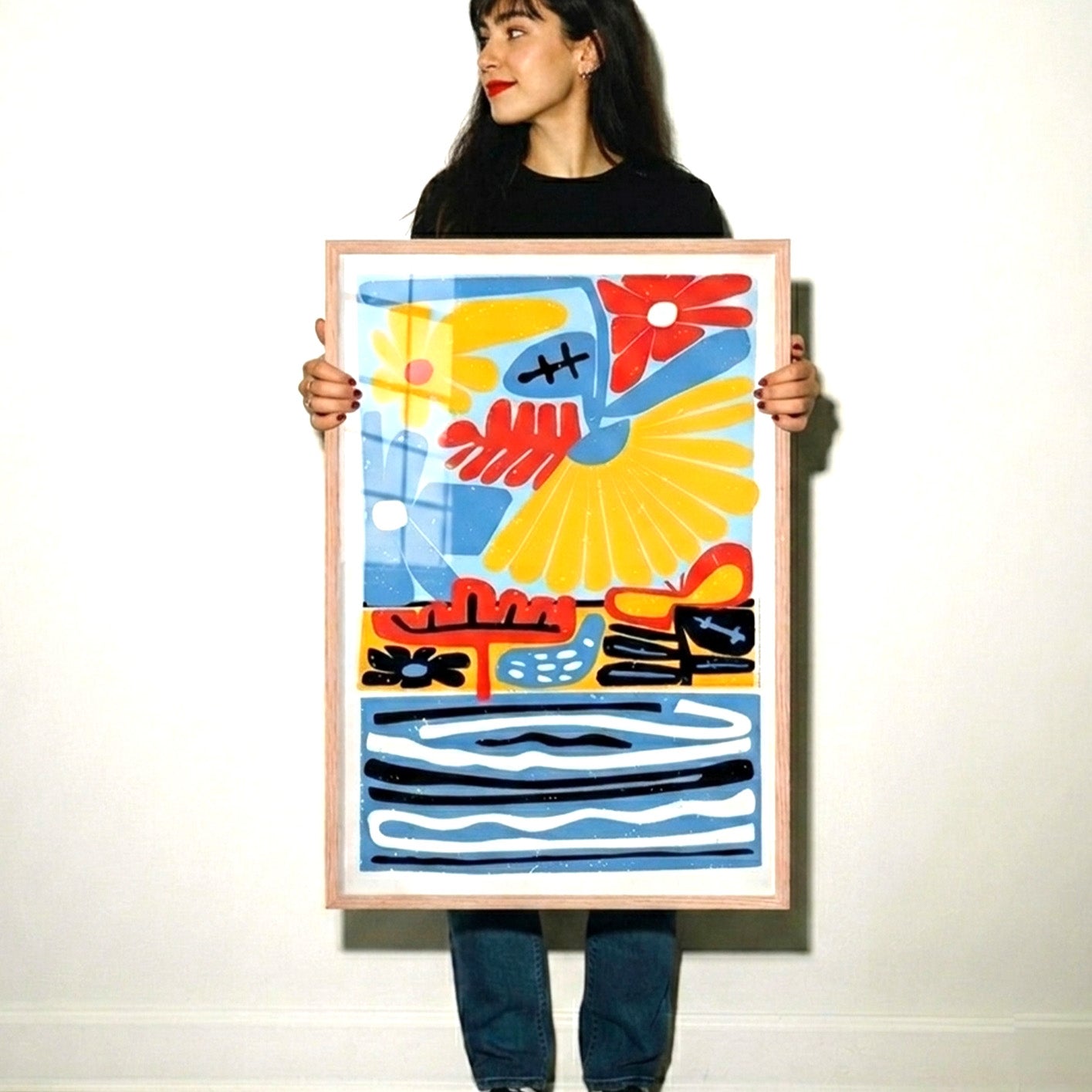 Woman holding a colorful abstract painting against a white background