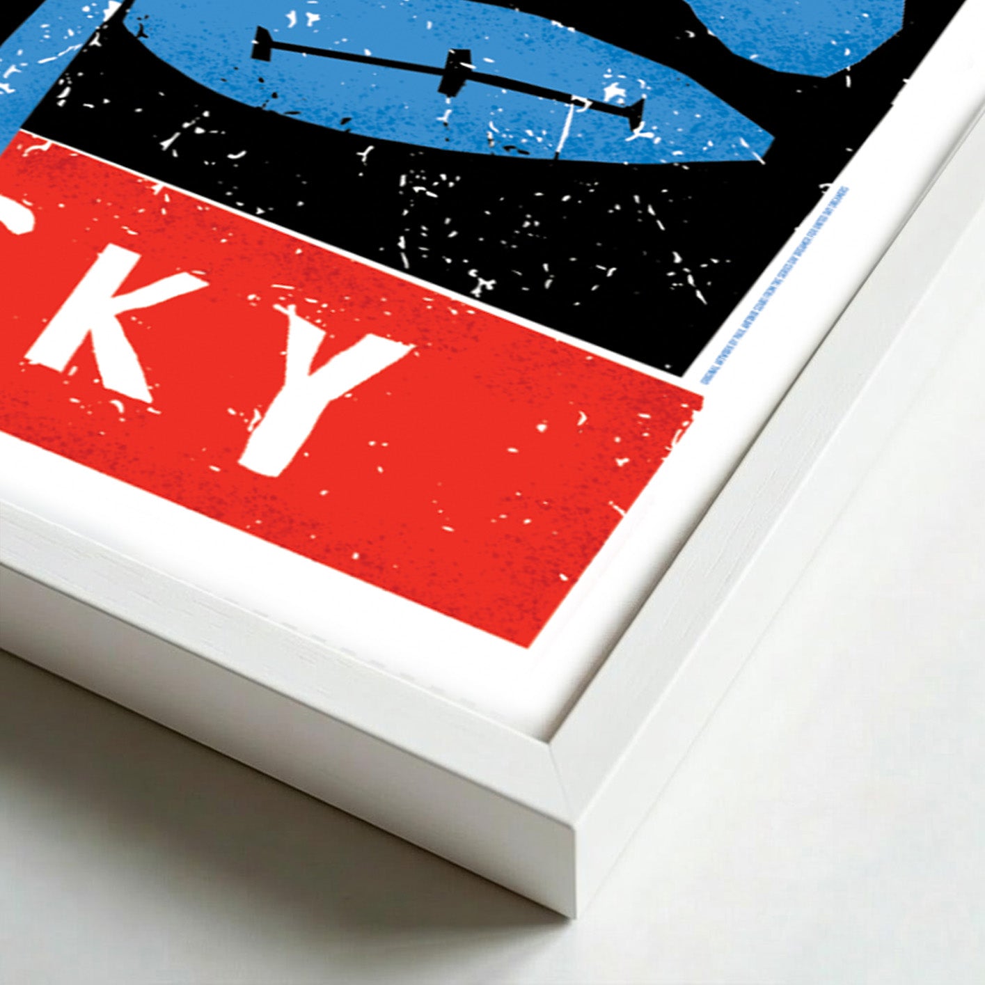 Detail of a framed artwork with abstract design featuring red, blue, and black colors on a white background.